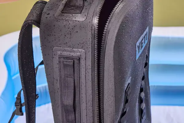 The Yeti Panga 28L Waterproof Backpack is sprayed with water