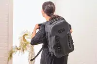 A person wears the Yeti Panga 28L Waterproof Backpack