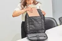 Person putting a tablet in the Solo Re:Define Backpack