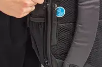 Hand unzipping the side of the Solo Re:Define Backpack