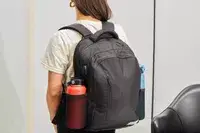 Person wearing the Solo Re:Define Backpack with water bottles in each side pocket