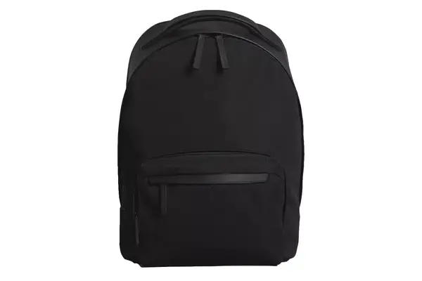 Hand putting laptop into Kühl Eskape 25 Backpack