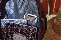 Phone and notebooks inside the Solo Re:Define Backpack