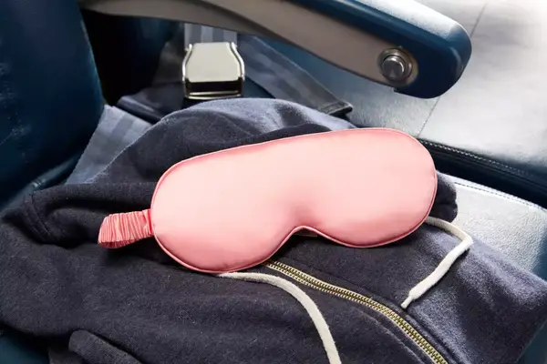 Slip Lovely Lashes Contour Sleep Mask on an airplane seat