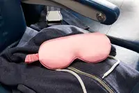 Slip Lovely Lashes Contour Sleep Mask on an airplane seat