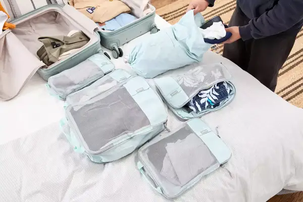 A person packing clothes in a bagsmart compression packing cubes