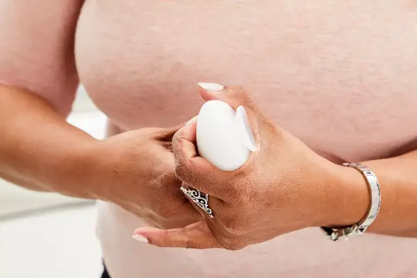 Person holding Liquisnugs Premium Leak-Proof Silicone Travel Bottles