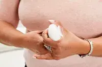 Person holding Liquisnugs Premium Leak-Proof Silicone Travel Bottles