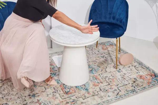 A woman shoves the Cuyana Travel Jewelry Case off of a table during testing