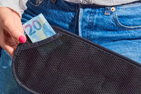 A person places money into the Raytix RFID Money Belt