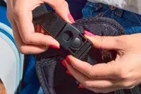 Hands buckling a Raytix RFID Money Belt