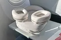 Bowers & Wilkins px6 s2e Headphones on an airplane tray table