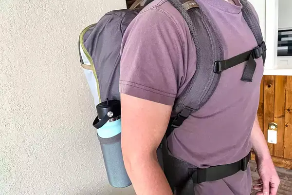 Side view of a person wearing a Cotopaxi Allpa 42L Travel Pack