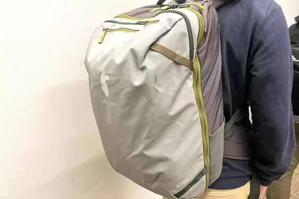 A person carries a Cotopaxi Allpa 42L Travel Pack on their back