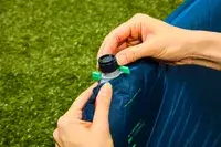 Hands removing the cap on the inflation valve on the Therm-a-Rest BaseCamp Sleeping Pad