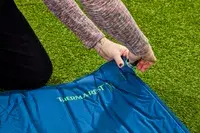 Hands placing a cap on the inflation valve on the Therm-a-Rest BaseCamp Sleeping Pad