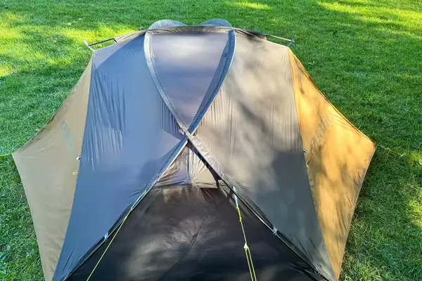 The Kuiu Mountain Star 2 Person Tent with cover on grass