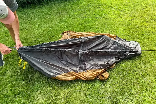 A person assembles the Kuiu Mountain Star 2 Person Tent