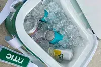 Ice and canned beverages inside the RTIC Insulated Soft Cooler Bag