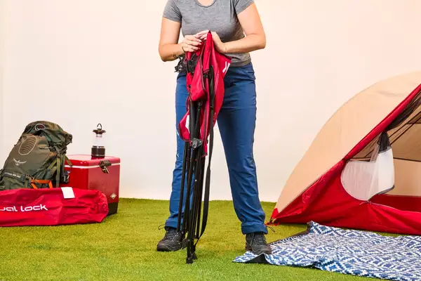 Someone unfolding the Kijaro Dual Lock Camping Chair