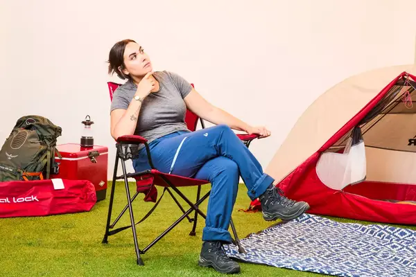 Someone sits on the Kijaro Dual Lock Camping Chair