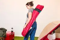 Someone wearing the Kijaro Dual Lock Camping Chair pouch on their shoulder