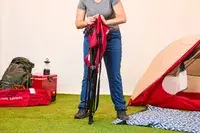 Someone unfolding the Kijaro Dual Lock Camping Chair