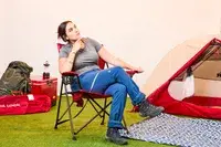 Someone sits on the Kijaro Dual Lock Camping Chair