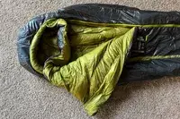 The Nemo Coda Genderless Endless Promise Down Mummy Sleeping Bag folded over exposing the inside