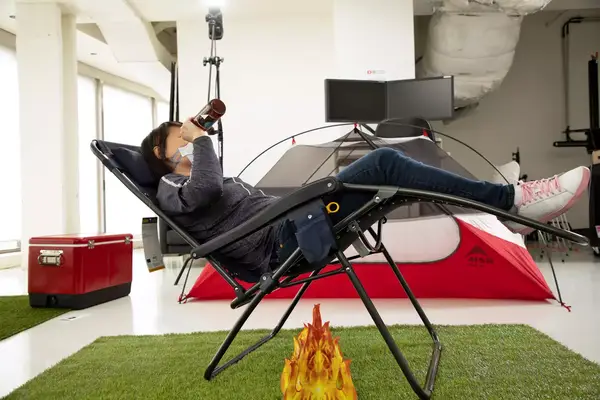 A dog sits inside the Kuiu Mountain Star 2 Person Tent under a handing light