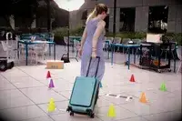 A person adjusting the latch on the Carl Friedrik The Carry-on