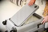 A person expands the Monos Expandable Carry-on Pro