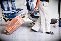 A person wheels the Calpak Ambeur Carry-On