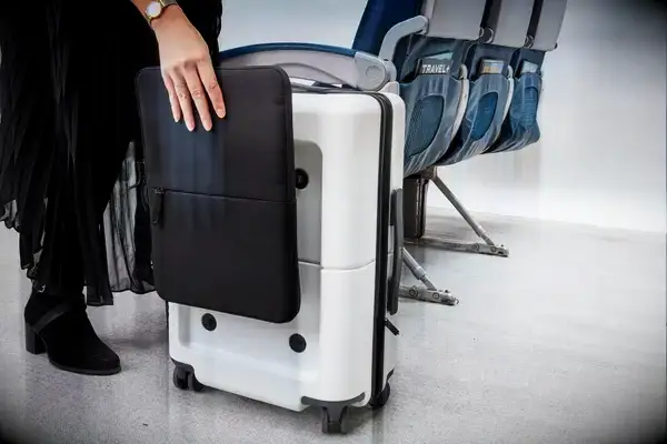 Person using the SnapSleeve of the July Carry On Pro SnapSleeve near airplane seats