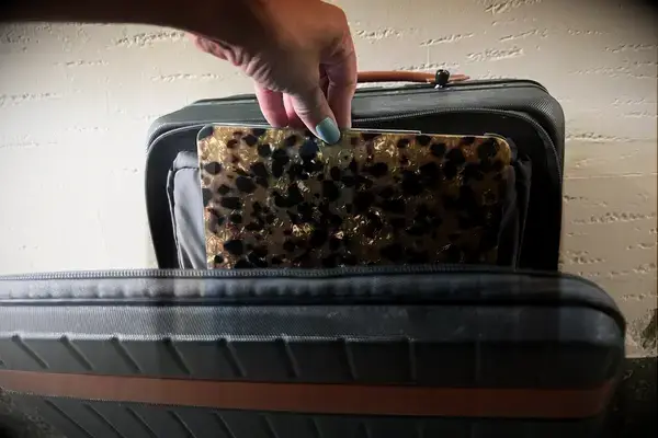 A person placing a laptop inside the Carl Friedrik The Carry-on X