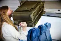 A person lifting the Dagne Doverr Seattle Carry On Rolling Luggage 20.5