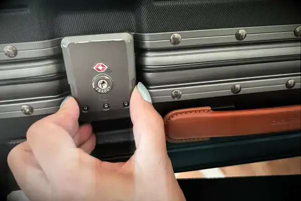 A person adjusting the latch on the Carl Friedrik The Carry-on