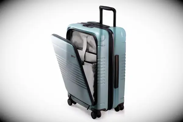 A person placing a laptop inside the Carl Friedrik The Carry-on X