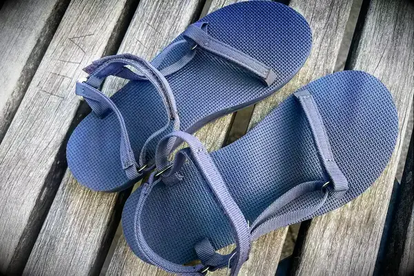 Teva Original Universal Slim Sandal on a wood background