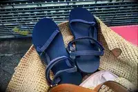 Teva Original Universal Slim Sandal in a rattan beach bag