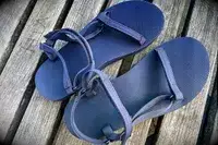 Teva Original Universal Slim Sandal on a wood background