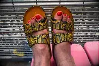 A persons feet wearing the Freedom Moses Freedom Slides