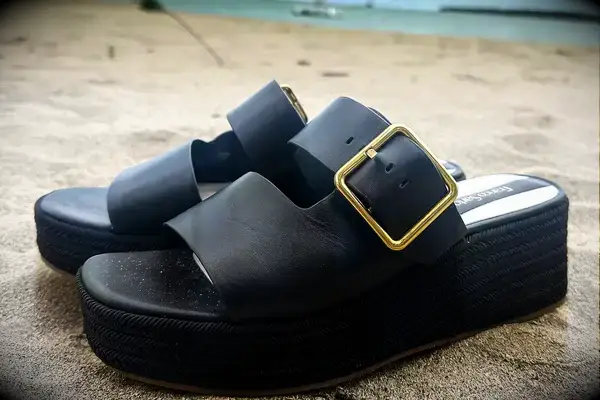 Side view of the Franco Sarto Taziana Espadrille Slide Sandals on the sand