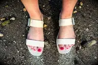 Top view of a person wearing the Bared Footwear Sanderlings on the sand