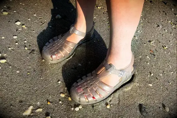 a person wearing the Melissa Possession Jelly Fisherman Sandal in the sand