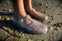 Side view of a person wearing the Melissa Possession Jelly Fisherman Sandal on the sand