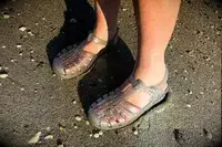 a person wearing the Melissa Possession Jelly Fisherman Sandal in the sand
