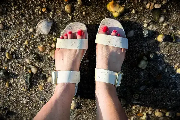 Top view of a person wearing the Bared Footwear Sanderlings on the sand