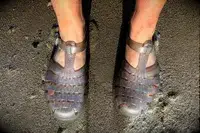 A person wearing the Melissa Possession Jelly Fisherman Sandal on the sand