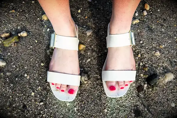 Top view of a person wearing the Bared Footwear Sanderlings on the sand